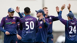 Photo: Cricket Scotland : Scotland national cricket team players celebrating a wicket during the match.
